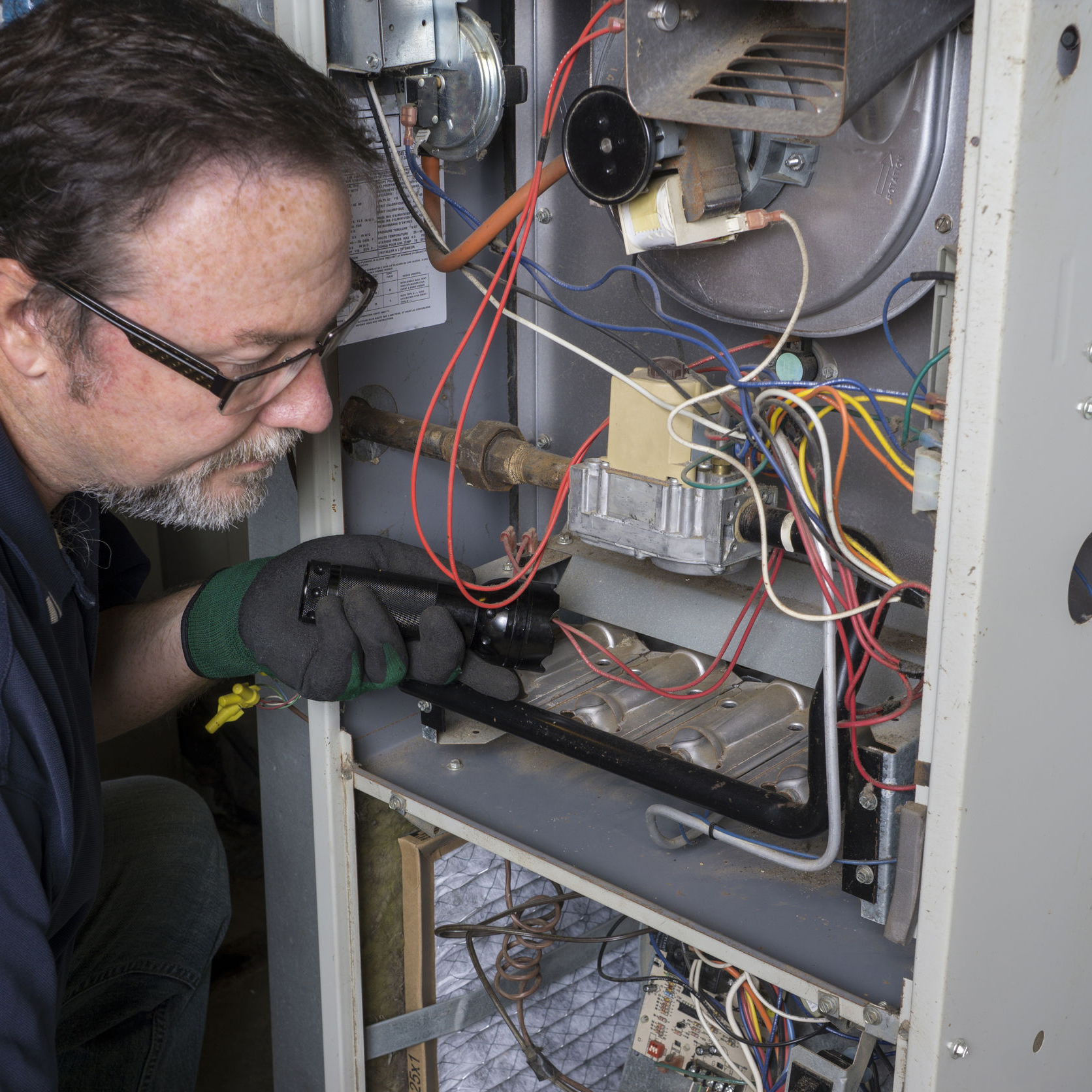 Technician working on an inducer motor