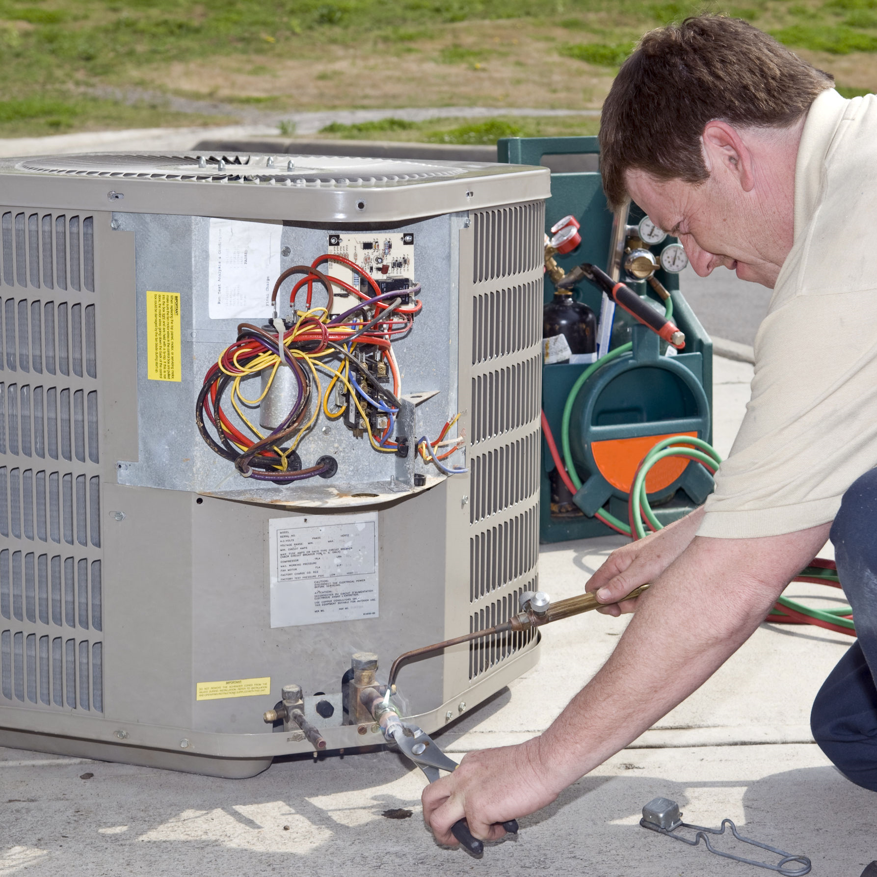 Technician repairing an AC unit.